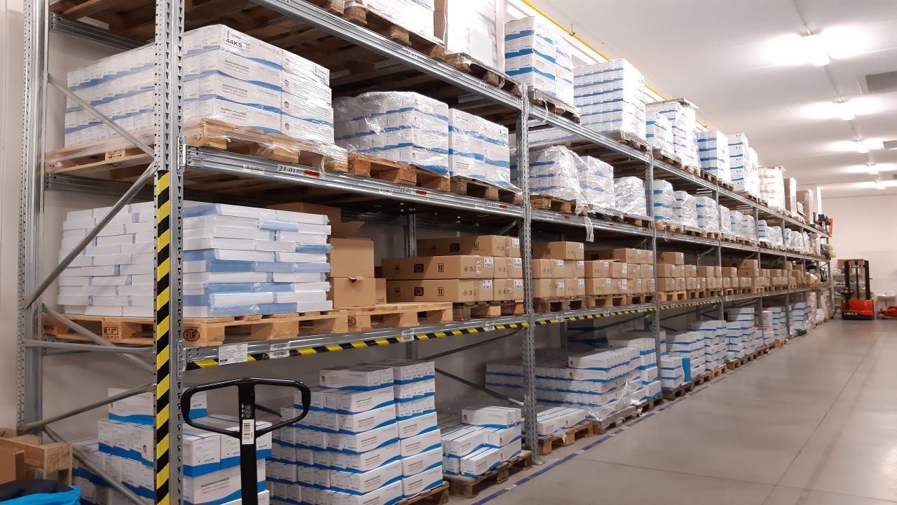 A warehouse filled with shelves of boxes and pallets, ready for storage and distribution. A warehouse filled with shelves of boxes and pallets, ready for storage and distribution.